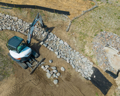 Machine filling channel with rocks